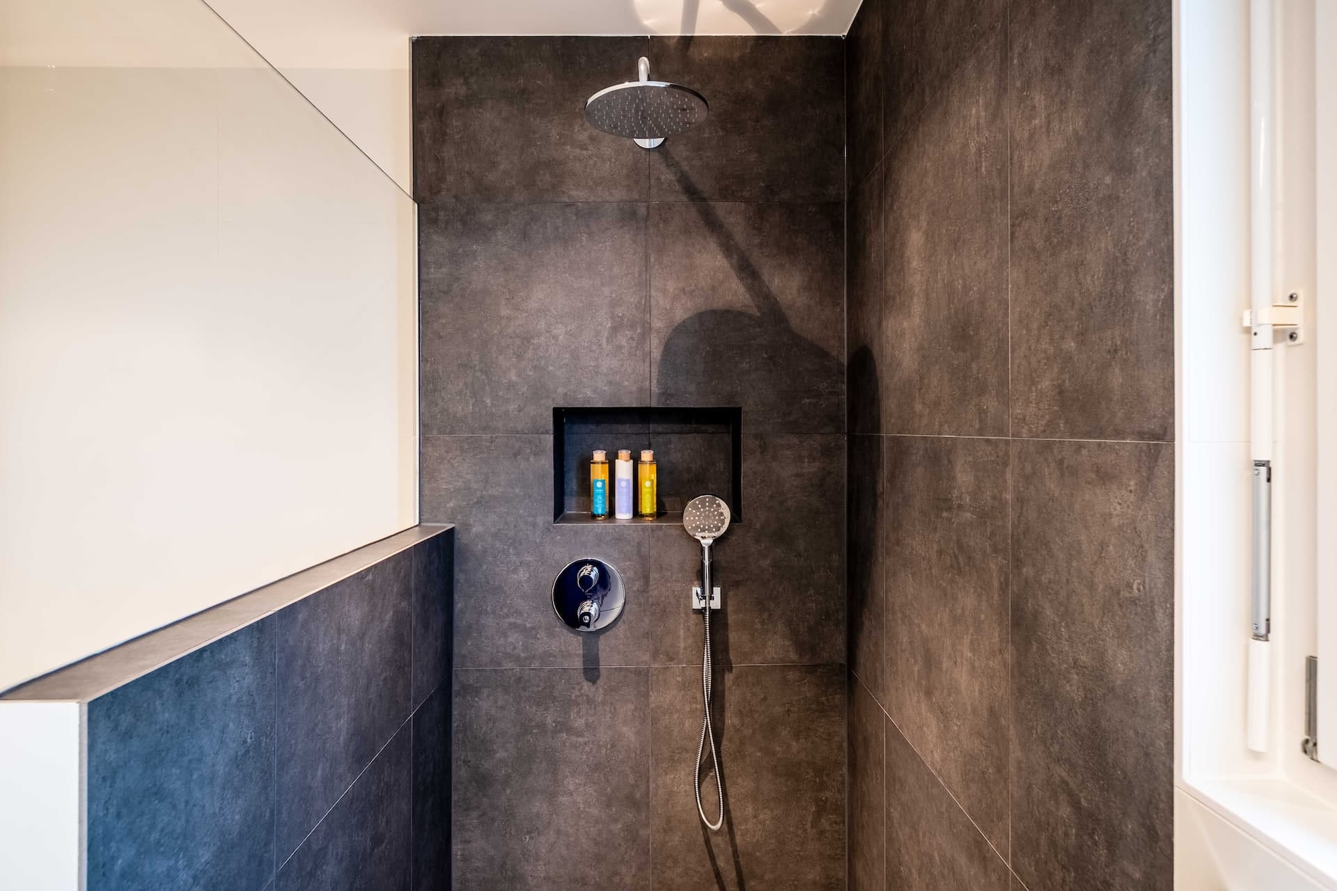 Modern tiled shower with fixture and niche for shower remodel planning